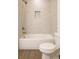 Stylish bathroom with a tiled shower-over-tub, built-in niche, and modern fixtures at 9002 Glenarm Way, Spring Hill, FL 34613