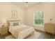 Cozy bedroom with natural light and minimalist decor, providing a serene retreat at 9002 Glenarm Way, Spring Hill, FL 34613