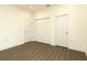 Bright bedroom with wood floors, three white doors, neutral paint, and ample space at 9002 Glenarm Way, Spring Hill, FL 34613