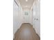 Clean hallway with wood floors, neutral paint, and white doors on either side leading to various rooms at 9002 Glenarm Way, Spring Hill, FL 34613