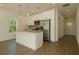 Bright kitchen featuring stainless steel appliances, granite countertops, and modern white cabinetry at 9002 Glenarm Way, Weeki Wachee, FL 34613