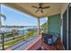 Enjoy breathtaking waterfront views from this condo's spacious balcony with seating and ceiling fan at 1038 Bellasol Way # 202, Apollo Beach, FL 33572