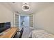 Versatile bedroom space with French doors and a desk, perfect for a home office or guest room at 1038 Bellasol Way # 202, Apollo Beach, FL 33572