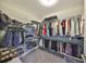 Spacious walk-in closet equipped with shelving and hanging space for organization at 1038 Bellasol Way # 202, Apollo Beach, FL 33572