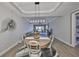 Open-concept dining room with modern lighting and views into the living area at 1038 Bellasol Way # 202, Apollo Beach, FL 33572