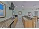 Charming kitchenette with a stainless steel sink, granite countertops, and nautical decor at 1038 Bellasol Way # 202, Apollo Beach, FL 33572