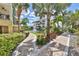 Well-manicured landscaped path with a fountain and tropical foliage at 1038 Bellasol Way # 202, Apollo Beach, FL 33572