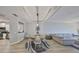 Cozy living space with adjacent dining area and kitchen, featuring tray ceilings and modern finishes at 1038 Bellasol Way # 202, Apollo Beach, FL 33572