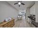 Open-concept living space featuring wood-look floors, a desk, and a view to the kitchen at 1038 Bellasol Way # 202, Apollo Beach, FL 33572