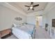 Cozy main bedroom featuring modern decor and carpet flooring at 1038 Bellasol Way # 202, Apollo Beach, FL 33572