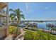 Scenic view of the waterway with boats docked, framed by lush tropical foliage at 1038 Bellasol Way # 202, Apollo Beach, FL 33572