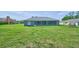 Lush backyard offers ample space for entertainment with views of the home's screened in porch at 12037 Conway St, Spring Hill, FL 34609