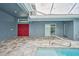 Exterior view of the backyard patio and pool with access doors to the home at 12037 Conway St, Spring Hill, FL 34609