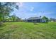 Expansive green backyard perfect for outdoor activities with a view of the home's screened-in porch at 12037 Conway St, Spring Hill, FL 34609