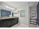 Bathroom featuring granite counters, dual sinks, and modern fixtures at 12037 Conway St, Spring Hill, FL 34609