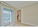 Bright bedroom featuring sliding glass doors to the pool and walk-in closet at 12037 Conway St, Spring Hill, FL 34609