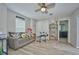 Cozy room featuring a comfortable couch, ceiling fan, and laminate flooring at 12037 Conway St, Spring Hill, FL 34609