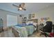 Bright bedroom with a ceiling fan, desk and wall art at 12037 Conway St, Spring Hill, FL 34609