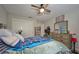 Bright bedroom with a ceiling fan, closet, and wood-look dresser at 12037 Conway St, Spring Hill, FL 34609