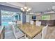 Elegant dining room with chandelier and view of the outside pool area at 12037 Conway St, Spring Hill, FL 34609