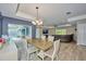 Elegant dining room with chandelier and view of the outside pool area at 12037 Conway St, Spring Hill, FL 34609