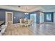 Bright dining room featuring modern chandelier, blue accent wall, and easy access to the pool at 12037 Conway St, Spring Hill, FL 34609