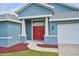 Inviting front entrance with a red double door and well-maintained landscaping at 12037 Conway St, Spring Hill, FL 34609