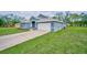 A well-manicured lawn and an attached two-car garage enhance the beautiful exterior of this house at 12037 Conway St, Spring Hill, FL 34609
