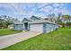 A well-manicured lawn and an attached two-car garage enhance the beautiful exterior of this house at 12037 Conway St, Spring Hill, FL 34609