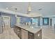 Open kitchen with a granite island, stainless steel appliances, and adjacent dining and living areas at 12037 Conway St, Spring Hill, FL 34609