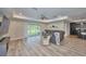 Open-concept living room with a large sectional sofa, bar seating, and hardwood floors at 12037 Conway St, Spring Hill, FL 34609