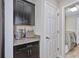 Convenient butler's pantry adjacent to the kitchen and laundry room with matching granite countertops at 12037 Conway St, Spring Hill, FL 34609