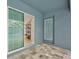 Outdoor patio with a sliding glass door and access door leading to pool area at 12037 Conway St, Spring Hill, FL 34609