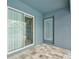 View of the exterior patio featuring a door and a sliding glass door entering the home at 12037 Conway St, Spring Hill, FL 34609