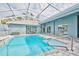 Wide view of the screened-in outdoor pool and patio area in backyard at 12037 Conway St, Spring Hill, FL 34609