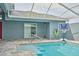 Outdoor pool view with basketball hoop and exterior features of the home at 12037 Conway St, Spring Hill, FL 34609
