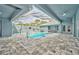 View of the beautiful screened-in pool and paved patio area with many points of entry to the home at 12037 Conway St, Spring Hill, FL 34609