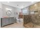 Well-lit bathroom featuring a walk-in shower and gray vanity at 1205 Hounds Run, Safety Harbor, FL 34695