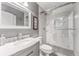 Bright bathroom with a glass shower, white vanity and marble floors at 1205 Hounds Run, Safety Harbor, FL 34695