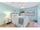 Bright bedroom with a white bed, light blue walls and carpeted floors at 1205 Hounds Run, Safety Harbor, FL 34695
