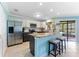 Bright kitchen with granite countertops, stainless steel refrigerator and access to the patio at 1205 Hounds Run, Safety Harbor, FL 34695