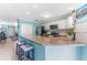 Open kitchen with a breakfast bar, granite countertops, and updated appliances at 1205 Hounds Run, Safety Harbor, FL 34695