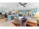 Inviting living room with tile flooring, neutral colors, and seamless access to the kitchen and screened in patio at 1205 Hounds Run, Safety Harbor, FL 34695