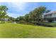 Serene pond view from home's backyard with blue skies at 1205 Hounds Run, Safety Harbor, FL 34695