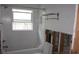Bathroom with a white tub and exposed studs ready for remodeling at 125 11Th Ave, Indian Rocks Beach, FL 33785