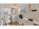 Bright bathroom featuring a modern vanity, mirror, and a window for natural light at 125 11Th Ave, Indian Rocks Beach, FL 33785