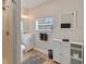 Clean bathroom featuring a white vanity, shower and a window for natural light at 125 11Th Ave, Indian Rocks Beach, FL 33785