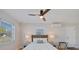 Bright bedroom with a ceiling fan, a woven headboard and a full size bed and bedside tables at 125 11Th Ave, Indian Rocks Beach, FL 33785