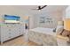 Bedroom featuring a TV, dresser, a comfortable bed, and a view into the dining room at 125 11Th Ave, Indian Rocks Beach, FL 33785
