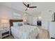 Bright bedroom with a ceiling fan, a woven headboard and a full size bed with laundry room view at 125 11Th Ave, Indian Rocks Beach, FL 33785